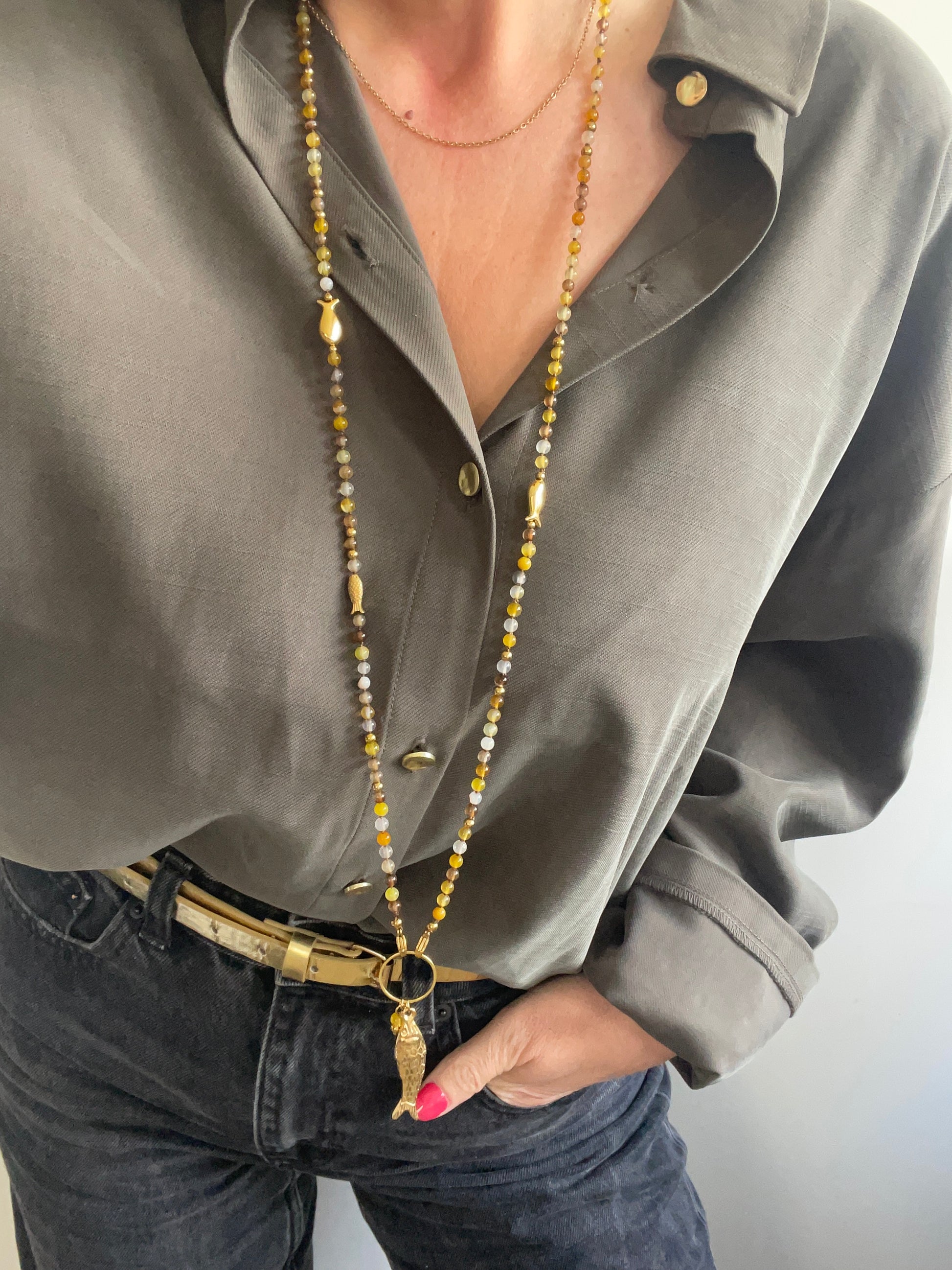 Porté collier sautoir le poisson Jacqueline tons jaune marron et doré sur chemise kakie
