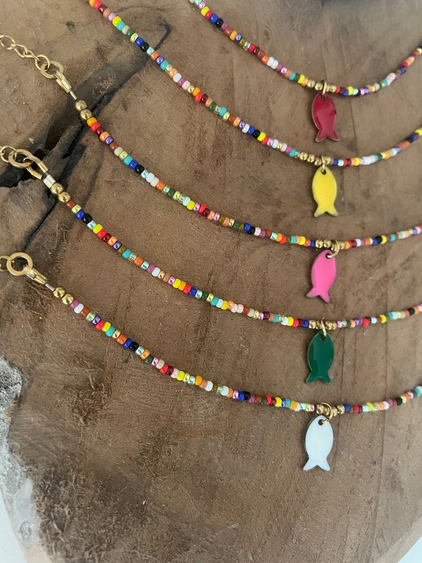 Gros plan breloques poissons colorés bracelets cirque aquatique doré